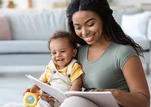 mom reading to toddler on her lap