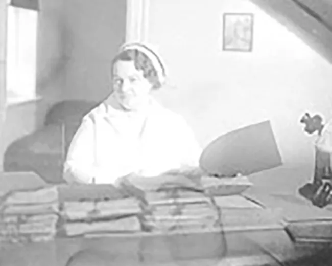 rene caisse at her desk